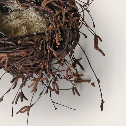 Close-up of handwoven birch twig nest sculpture with reindeer moss by Irish artisan Joe Hogan, created from natural materials gathered across the Irish landscape.