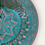 Plato Calado Estrella openwork ceramic wall plate by Pablo Tito with green and brown tones, featuring an intricate star motif, handcrafted in Andalusia, Spain.