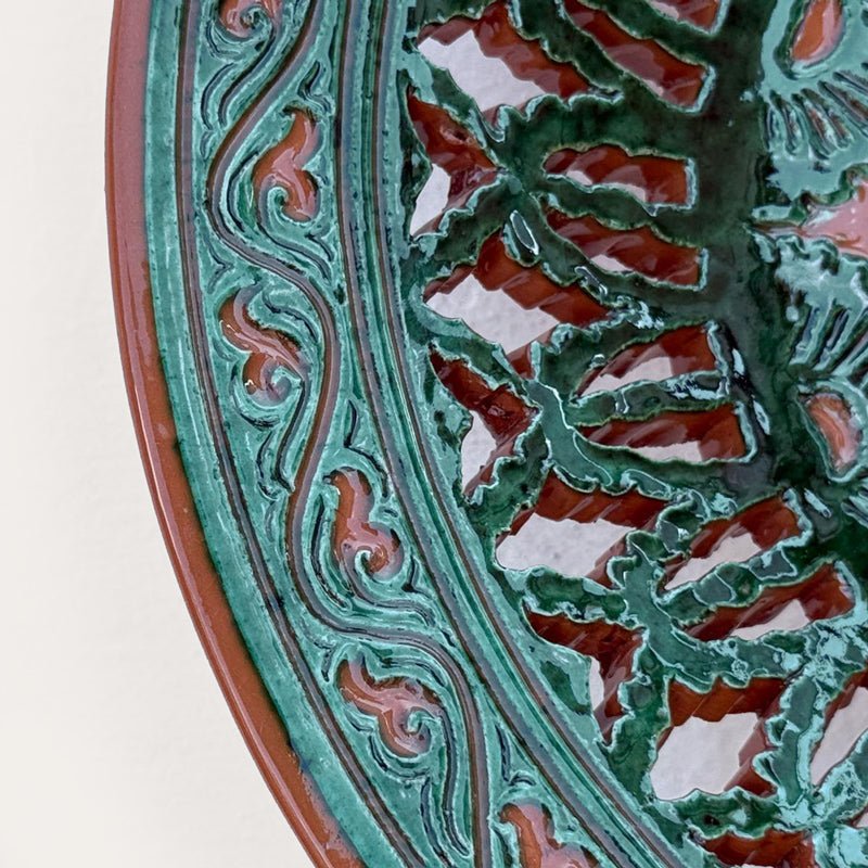Plato Calado Estrella openwork ceramic wall plate by Pablo Tito with green and brown tones, featuring an intricate star motif, handcrafted in Andalusia, Spain.