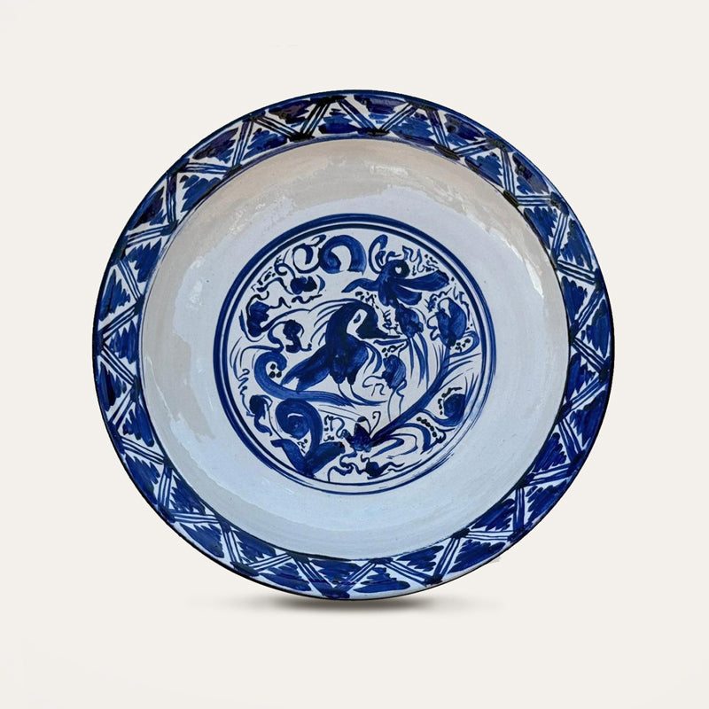 Plato Renacentista hand-painted ceramic wall plate by Pablo Tito with blue and white decorative motifs, handcrafted in Andalusia, Spain.