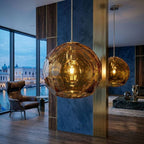 Medium amber spherical Murano glass pendant lamp with a hand-sculpted faceted surface, handcrafted on Murano Island in Venice, Italy.
