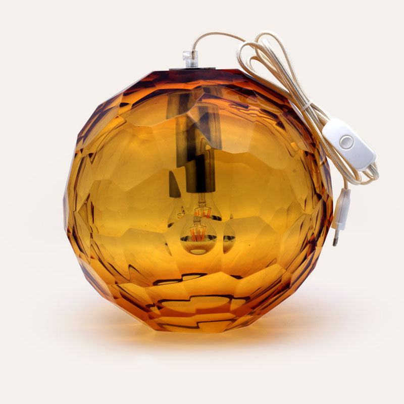 Medium amber spherical Murano glass pendant lamp with a hand-sculpted faceted surface, handcrafted on Murano Island in Venice, Italy.