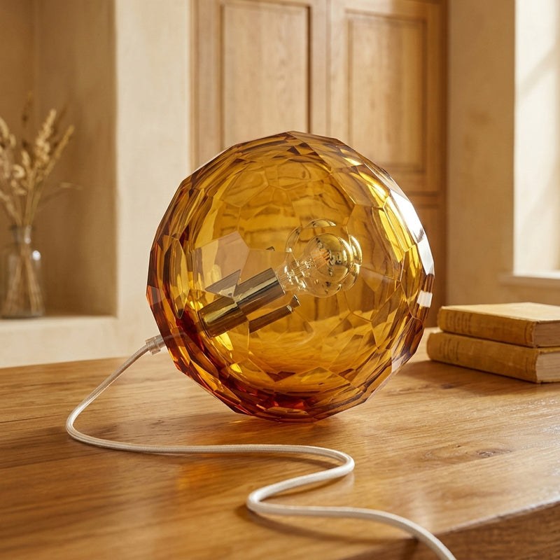 Medium amber spherical Murano glass table lamp with a hand-sculpted faceted surface, handcrafted on Murano Island in Venice, Italy.