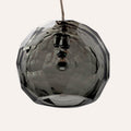 Medium grey spherical Murano glass pendant lamp with a hand-sculpted faceted surface, handcrafted on Murano Island in Venice, Italy.