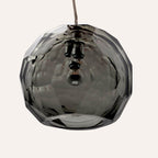 Medium grey spherical Murano glass pendant lamp with a hand-sculpted faceted surface, handcrafted on Murano Island in Venice, Italy.