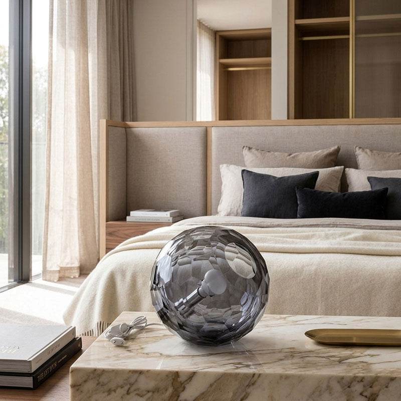 Medium grey spherical Murano glass table lamp with a hand-sculpted faceted surface, handcrafted on Murano Island in Venice, Italy.
