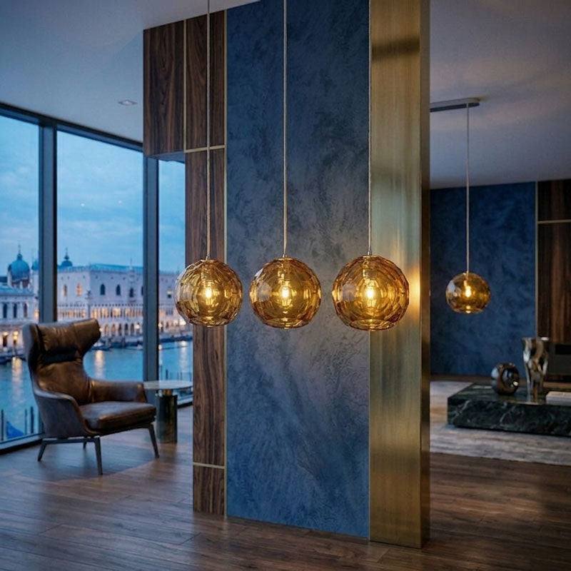 Small amber spherical Murano glass pendant lamp with a hand-sculpted faceted surface, handcrafted on Murano Island in Venice, Italy.