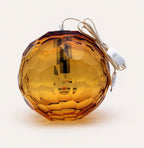 Small amber spherical Murano glass pendant lamp with a hand-sculpted faceted surface, handcrafted on Murano Island in Venice, Italy.