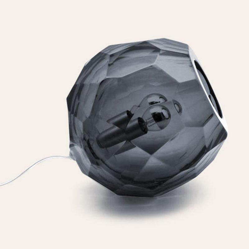 Small grey spherical Murano glass table lamp with a hand-sculpted faceted surface, handcrafted on Murano Island in Venice, Italy.