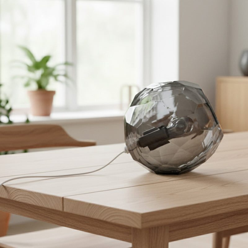 Small grey spherical Murano glass table lamp with a hand-sculpted faceted surface, handcrafted on Murano Island in Venice, Italy.