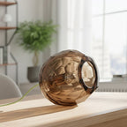Small tobacco spherical Murano glass table lamp with a hand-sculpted faceted surface, handcrafted on Murano Island in Venice, Italy.